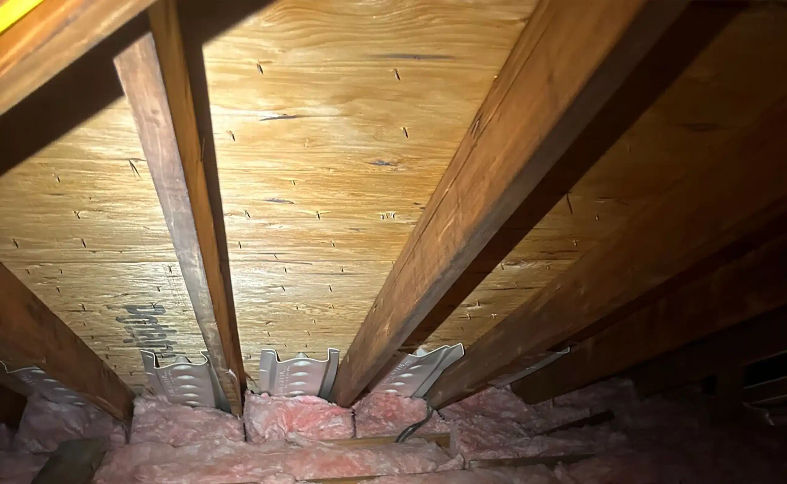 Attic after mold remediation — clean wood sheathing