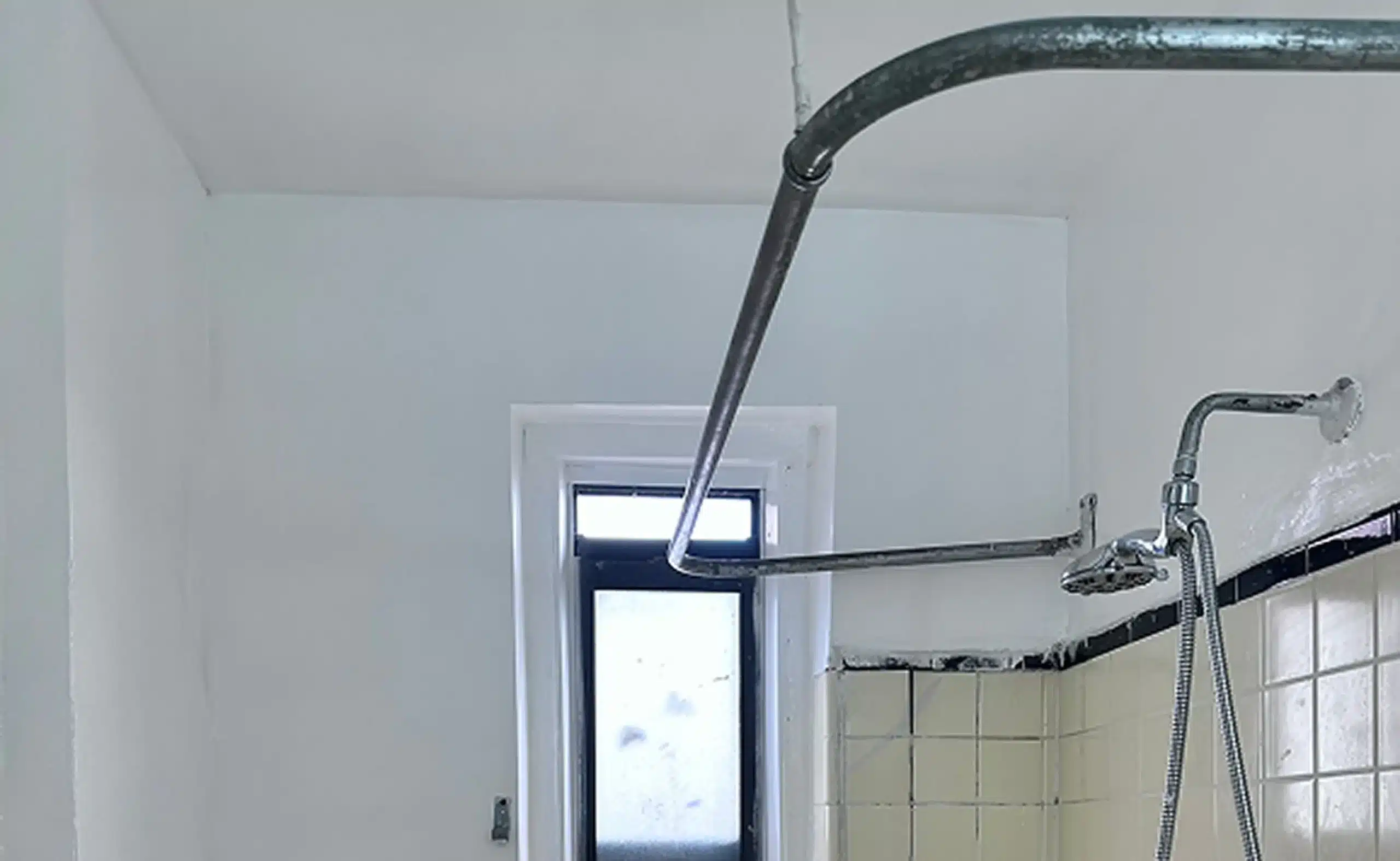 Bathroom after mold remediation — clean ceiling and walls